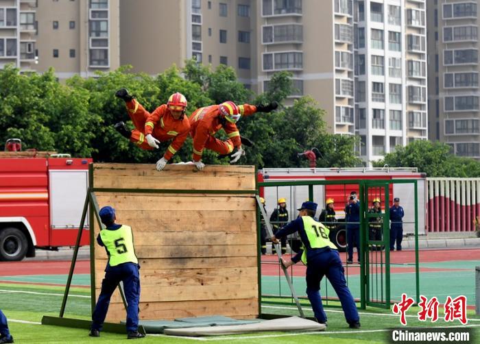新消防員進(jìn)行消防障礙接力操展示。　劉忠俊 攝